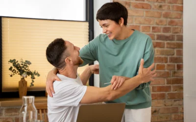 Couple celebrating pregnancy announcement at home, joyful expressions, embracing in a warm, inviting setting.